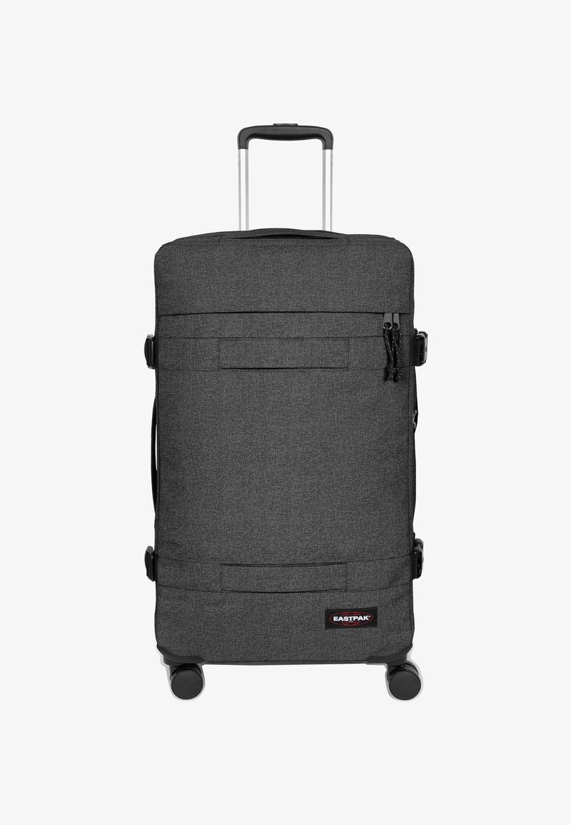 Valigia trolley in tessuto grigio scuro con texture liscia, manico superiore, manico retrattile e due ruote. Presenta cinghie frontali e logo.