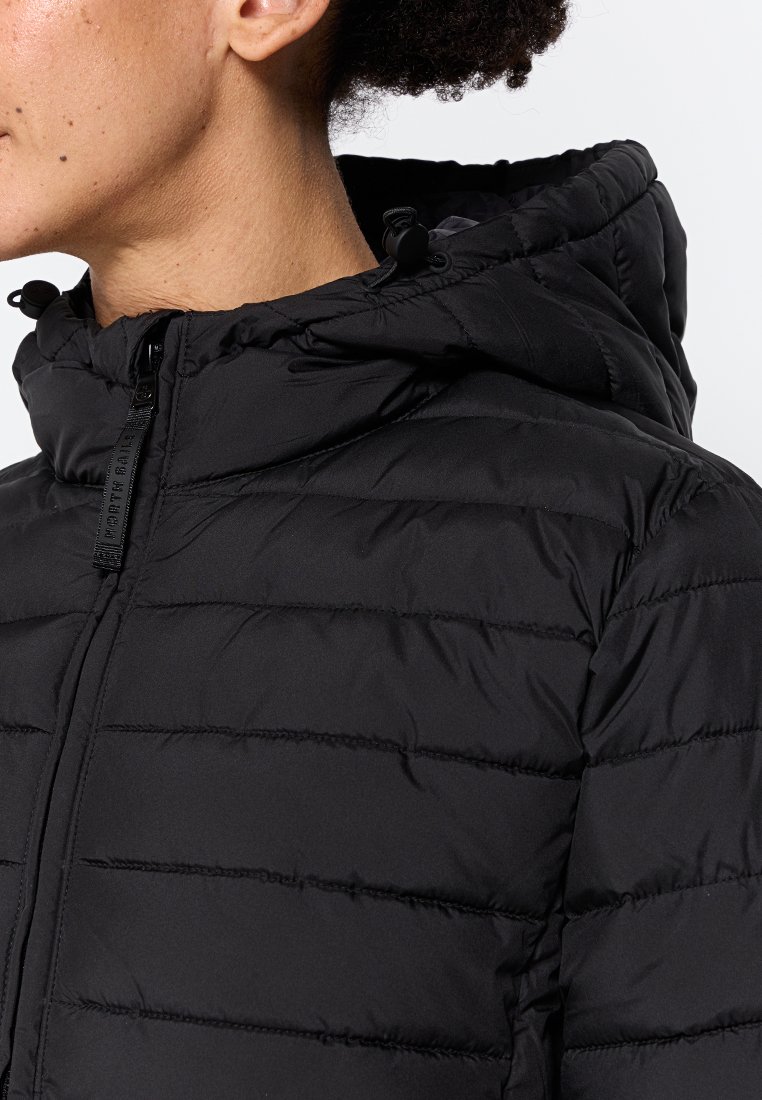 Giacca a vento nera con cappuccio, dotata di chiusura a zip frontale, texture trapuntata e corde di regolazione. Materiale liscio con silhouette aderente.