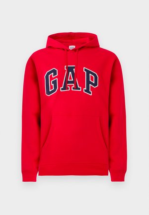 Red hoodie made of cotton, featuring a front pocket, drawstring hood, and "GAP" logo in navy blue across the chest.