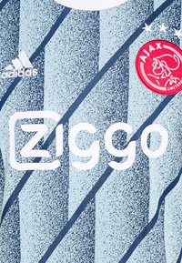 Vaaleansininen urheilu paita, jossa tummansiniset vinoraidat. Tässä paidassa on valkoinen "Ziggo"-logo ja punainen Ajax-embleemi, jonka yläpuolella on kolme tähteä.