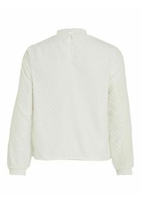 Blouse blanche à manches longues avec motif chevron texturé, poignets élastiques et petite fermeture bouton avec œillet dans le dos au niveau de l'encolure.