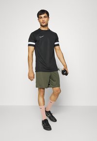 Nike Performance Calções desportivos - medium olive/white/night forest/white