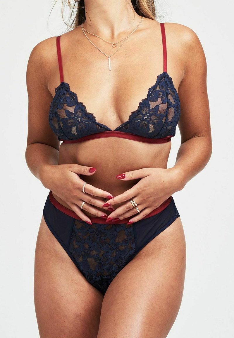 Ensemble de soutien-gorge en dentelle et culotte taille haute présentant des couleurs marine et bordeaux, des motifs floraux, des bretelles fines et une texture transparente.