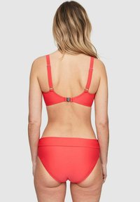 Röd bikiniuppsättning med en enkel design och en krokstängning bak samt matchande högmidjade bottnar. Slät, elastisk tyg.