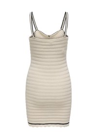Knit dress with a textured cream fabric, featuring a fitted shape, thin straps, and black accents at the neckline and hem.