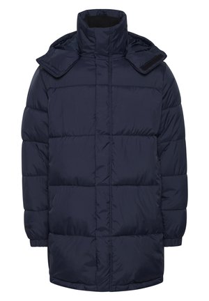 Jūras spēku pārgājienu jaka ar augstu apkakli, kam ir rāvējslēdzēja aizdare un divas kabatas ar rāvējslēdzēju. Audums ir gluds un nedaudz spīdīgs.