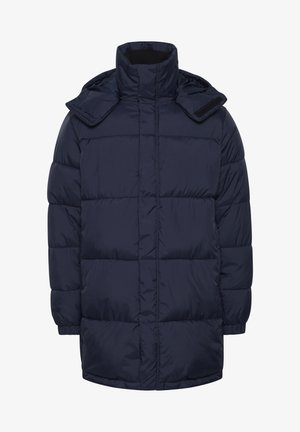 Jūras spēku pārgājienu jaka ar augstu apkakli, kam ir rāvējslēdzēja aizdare un divas kabatas ar rāvējslēdzēju. Audums ir gluds un nedaudz spīdīgs.