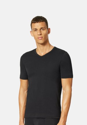 T-shirt nera a maniche corte con scollo a V, realizzata in morbido cotone, caratterizzata da un design aderente e uno stile minimalista senza loghi o fantasie visibili.