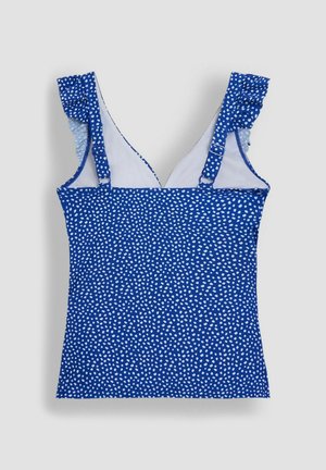 Blå top med hvide prikker, flæsebælter og V-hals design. Lavet af letvægtsstof med en glat tekstur.