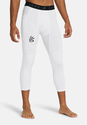 Leggings de sport blancs au design ajusté, présentant un logo CURRY noir sur la ceinture et un logo sur la cuisse. Texture lisse.