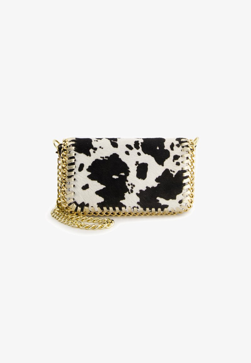 Cowhide crossbody bag in black and white with a gold chain strap and stitching accents. Features a compact rectangular shape.