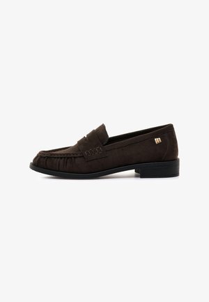 Mocassin en daim marron foncé avec un petit talon noir, couture mocassin et un petit accent doré sur le côté.