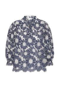 Blouse bleu marine avec motif en dentelle florale blanche, dotée d'un col en V, de manches bouffantes et d'un ourlet festonné. Tissu léger et transparent.