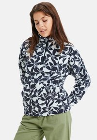 Fleece pullover met een ritskraag, voorzien van een marineblauw bloemenpatroon op een lichte achtergrond. Zachte textuur, aansluitend ontwerp en lange mouwen.