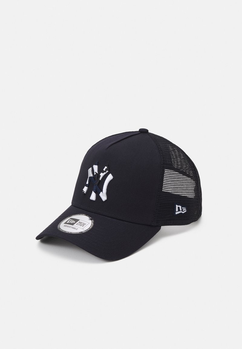 Black baseball cap with a mesh back, featuring an embroidered white logo on the front, adjustable strap, and curved visor.