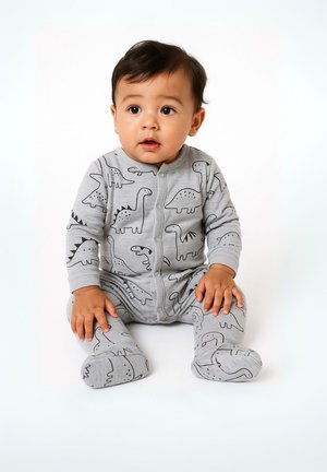 Un body en coton gris avec des imprimés de dinosaures noirs, à manches longues, fermetures à pression sur le devant et design avec pieds. Texture douce.