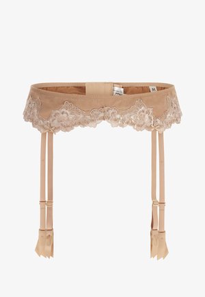 Ce porte-jarretelles en dentelle beige présente des bords festonnés, des sangles en satin et des nœuds décoratifs. Il est orné de quincaillerie en métal doré et a une texture lisse.