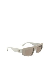 Calvin Klein sunglasses with a matte off-white frame, squared lenses in a brown tint, and a logo accent on the side.