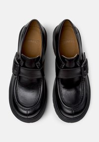 Black leather shoes with a rounded toe, buckle accent, and textured finish. Cushioned insole and rubber outsole for durability.