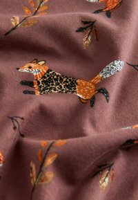 Fox and autumn leaves pattern on soft, mauve fabric with black, orange, and white details.