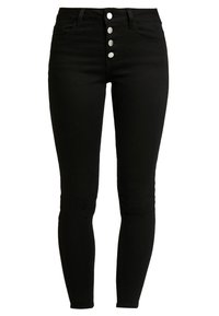 Jean skinny negros de tiro alto, elaborados en denim, con un cierre frontal de cinco botones y bolsillos traseros tradicionales. Textura suave y diseño ajustado.