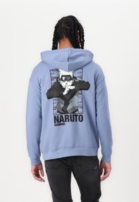 Light blue hoodie featuring a graphic of a character with a finger on lips, text "NARUTO UZUMAKI" below, and contrasting black accents.
