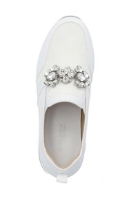 White slip-on sneaker with textured mesh upper and shiny crystal embellishments across the front. Flexible sole, minimal design, and pull tab.