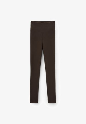 Bruine geribbelde legging met een hoge tailleband, voorzien van een gladde textuur en een aansluitend ontwerp, geschikt voor actieve of casual kleding.