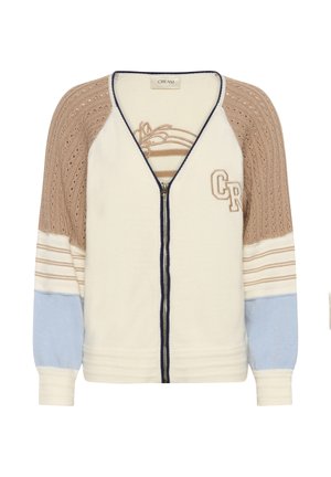 Cardigan crème à fermeture éclair avec un design texturé beige et bleu clair. Présente une bordure contrastante bleu marine et un logo brodé à l'avant.