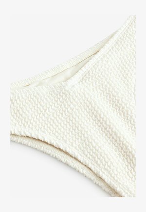 Textūruotas balta bikini viršus su banguota raštu, turintis be siūlių vidinį pamušalą ir lygų elastingą apdailą, užtikrinančią patogų prigludimą.