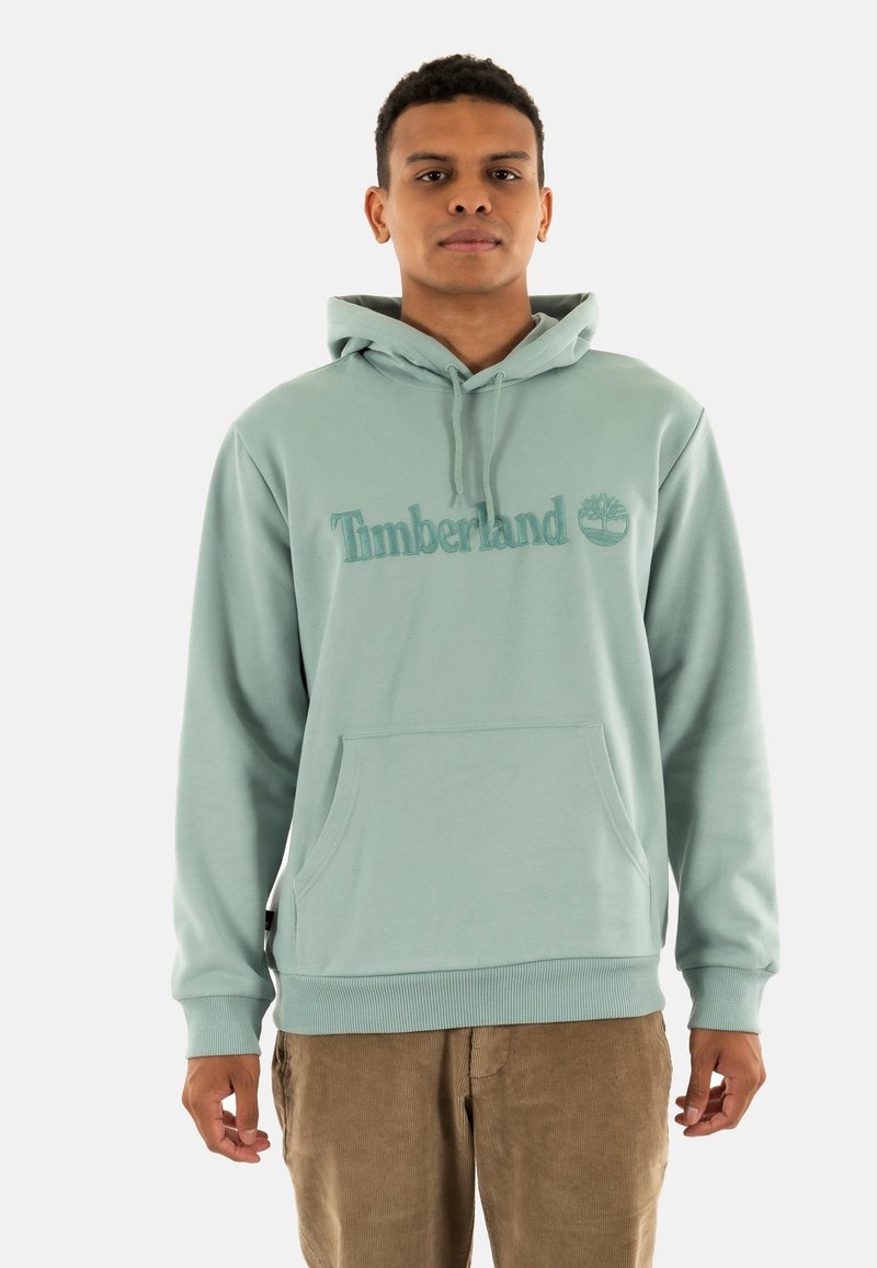 Felpa con cappuccio verde menta, dotata di tasca frontale, con logo "Timberland" ricamato e emblema dell'albero. Tessuto morbido con polsini a coste.