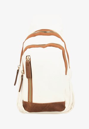 White faux leather backpack with brown accents. Features two zippered compartments and textured finish on the bottom. Gold hardware zippers.