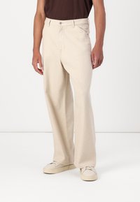 Beige wide-leg trousers made of denim, featuring a front button closure, side pockets, and a clean, textured finish.