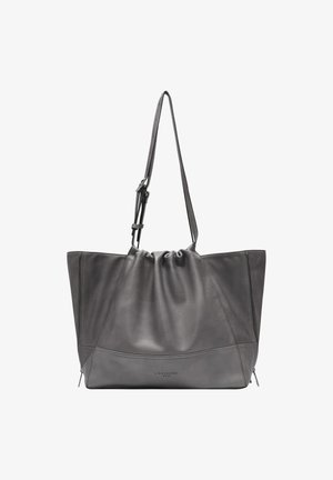 Gray leather tote bag with a gathered top, angular design, two side zipper pockets, and an adjustable shoulder strap.