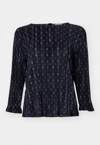 Langärmlige, dunkelmarine Bluse mit vertikalen Falten, kleinen kreisförmigen Mustern und Rüschenschläfen. Weicher, leichter Stoff.