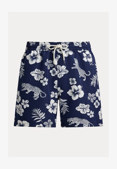 Pantalones cortos azul marino con cordón y patrones de flores tropicales blancas y estampado de leopardo moteado.