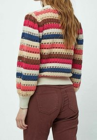 Knit sweater with multi-colored stripes in red, beige, blue, and brown. Features a textured design and ribbed cuffs and hem.