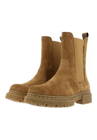 Hnědé semišové kotníkové boty s elastickými bočními panely, gumovou podrážkou a poutky na natažení. Mají texturovaný povrch a prošitý okraj kolem podrážky.