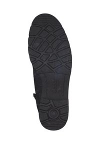 Mustast kummist jalanõu tall tekstuuriga mustri ja soonte ning röövritega haarduvuse parandamiseks. Keskele lähedal on ümarlik aksent.