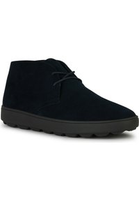 Botas de ante azul marino hasta el tobillo con punta redonda, suela de goma negra y cordones planos. Presentan un mínimo de costuras y un diseño de perfil bajo.
