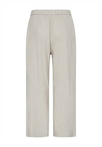Pantalon court beige clair à coupe ample avec ceinture élastique, sans poches visibles ni ornements, vue de face sur fond blanc.