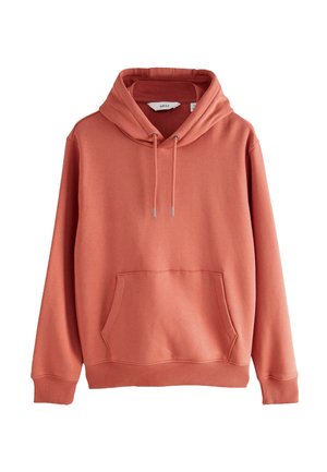 Coralowa bluza z kapturem, w stylu pulowera, wykonana z miękkiego materiału. Posiada przednią kieszeń, regulowany sznurek w kapturze oraz prążkowane mankiety i dół.