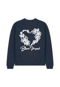Sweatshirt bleu marine avec un col rond. Présente un design floral blanc formant un cœur et le texte "Bloom Mood" en cursive en dessous.