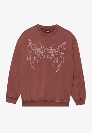 Sweatshirt bordeaux en coton, avec un design graphique blanc sur le devant. L'encolure est ronde, avec des poignets et un ourlet côtelés.