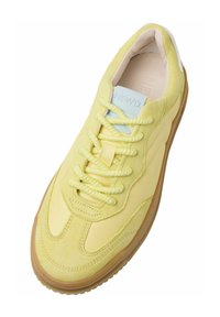Baskets jaunes avec une tige en daim et en cuir lisse, des lacets ronds, une étiquette sur la languette de couleur bleu clair et une semelle en gomme texturée.