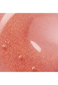 Shiny pink liquid with fine gold glitter particles and small air bubbles, showing a glossy and smooth texture.