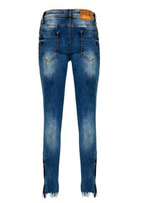Skinny jeans i denim med en blekt blå färg, fem fickor och kontrasterande sömmar. Rå fåll med sidoklyftor.