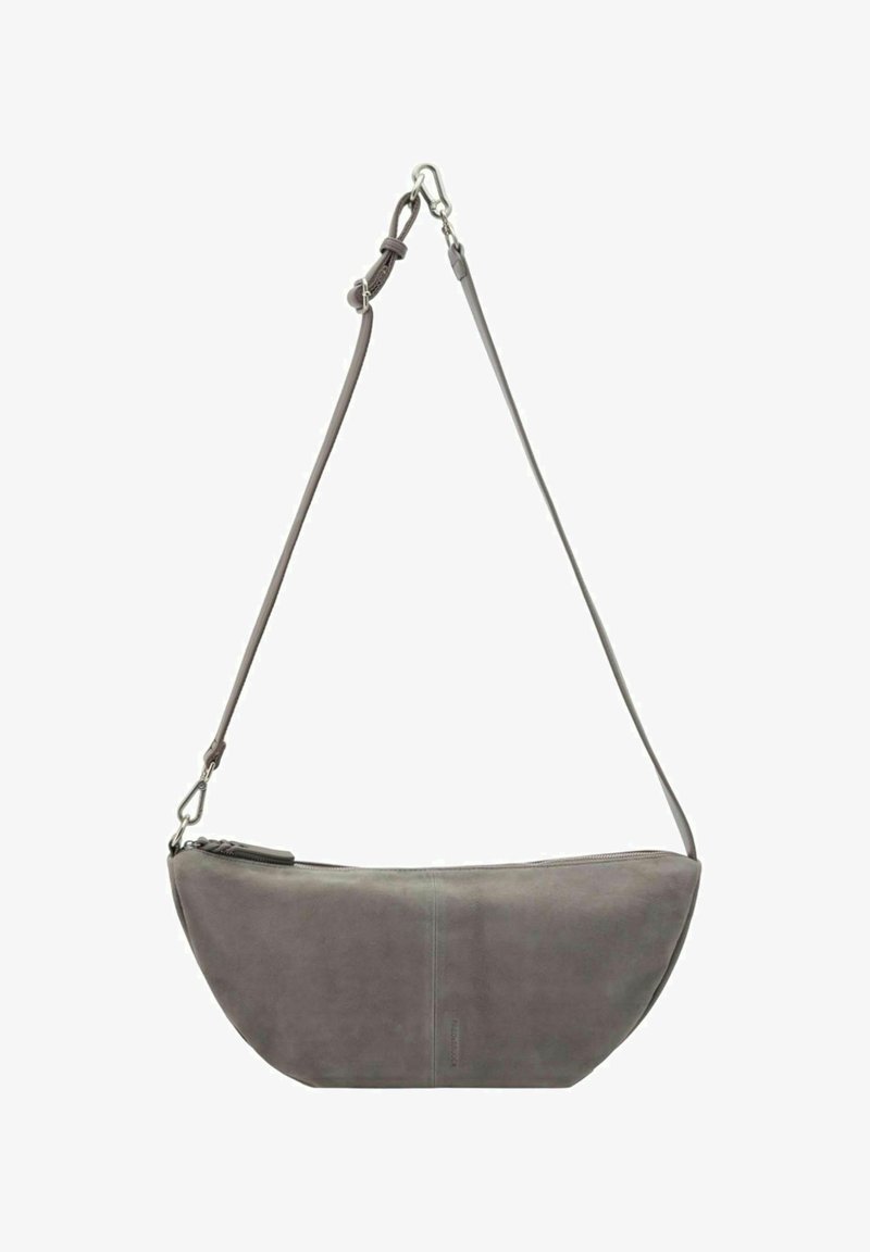 Grey leather sling bag with a curved shape, adjustable strap, zipper closure, and subtle embossed branding on the front.