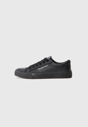 Black leather sneaker with round toe, textured rubber sole, lace-up design, and white "VALENTINO" logo on the side.