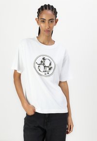 White cotton t-shirt with short sleeves, featuring a round graphic logo in black and gray, displayed against a neutral background.